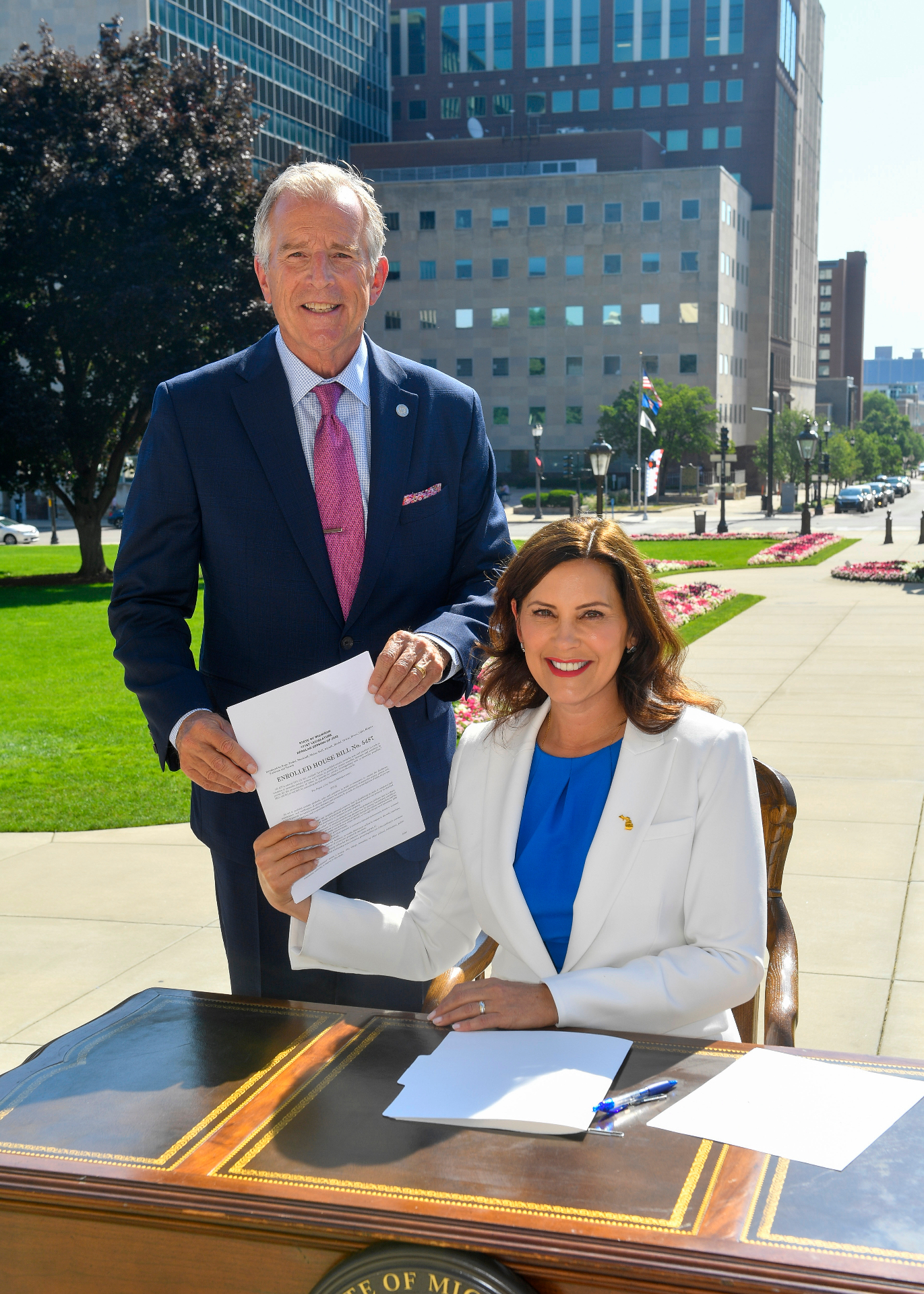Tisdel with Gov. Whitmer at the signing of his consumer protection law, House Bill 5487.